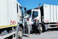 Célestine Eyeghe Etoumé et Esther Mahiet-Lucas, adjointe à la mairie de Thouars, posant devant les deux camions-bennes en partance vers Port-Gentil. © lanouvellerepublique.fr.