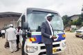 Le révérend André Philibert Binet devant l’un des bus de l’agence Elohim Transport, dont les activités ont été lancées, le 16 juillet 2022 à Libreville. © Gabonreview