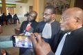 Trois des avocats de Patrichi Tanasa, dont Me Anges Kevin Nzigou (au milieu) après le rendu du verdict, le 20 juillet 2022. © Gabonreview