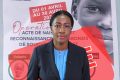 la ministre de la Justice Erlyne Antonella Ndembet-Damas, et derrière, l'affiche jugée mensongère. © Montage/Gabonreview